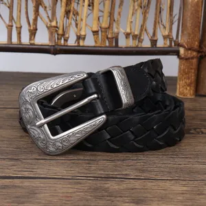 Detailed close-up of a vintage black braided leather belt with an ornate silver buckle