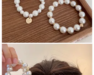 Detailansicht eines eleganten Perlen-Haargummis als stilvolles Accessoire für die Haare