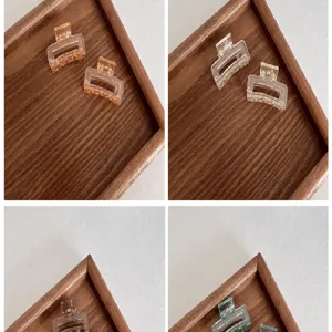 Detail view of 4cm square mini hair claw clips in various translucent candy colors.