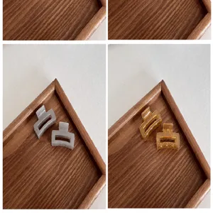 Detailed close-up of 4cm semi-transparent square hair claw clips in grey and amber