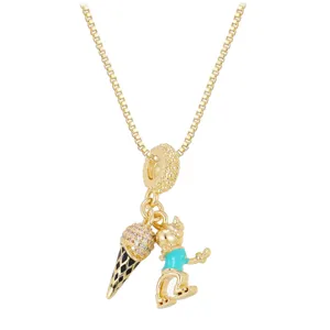 Detailed macro view of a gold box chain necklace with ice cream and cartoon girl charms