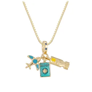 Detailed view of gold travel-themed charms featuring an airplane, passport, and ticket.