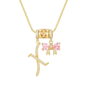 Vergoldete Halskette mit K-Anhänger und einer rosa Schleife aus Zirkonia-Herzen.