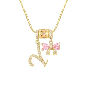 Zierliche 18k vergoldete Halskette mit L-Anhänger und rosa Zirkonia-Schleife für Damen.