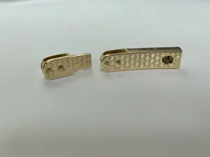 Close-up detail of the gold zinc alloy adjustable belt buckle component with geometric texture.