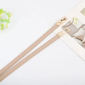 Women thin leather belt with elegant gold metal lock buckle, stylish dress accessory for daily wear.
