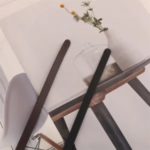 Slim leather belt for women, minimalist narrow design, perfect detail shot for dresses and shirts.