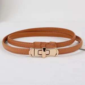 Women thin leather belt with gold metal lock buckle, elegant adjustable dress accessory.
