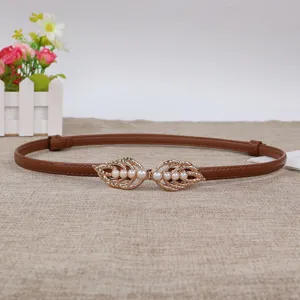 Slim brown leather waist belt for women, featuring a stylish gold leaf pearl snap buckle.