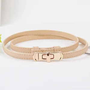 Adjustable thin beige leather belt for women with elegant metal lock buckle dress accessory.