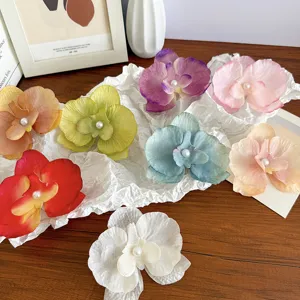Vibrant fairy-style orchid flower hair clips in multiple colors with pearl accents