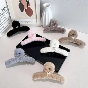 Large plush hair claw clips with sweet bow detail in assorted soft pastel colors