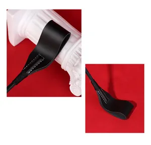 Black leather whip detail view, premium craftsmanship, smooth handle loop, durable material.
