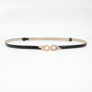Black patent leather thin belt with elegant gold pearl rhinestone flower buckle for dresses.