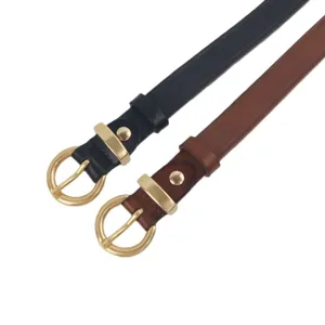 Detailed view of genuine leather belts with gold round buckles in black and brown colors.