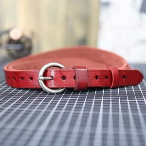 Red genuine leather belt detail showcasing star cutouts and metal round buckle design.