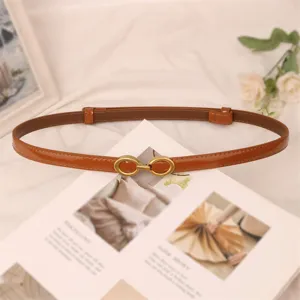 Minimalist brown patent leather thin belt for women, stylish dress waist accessory.
