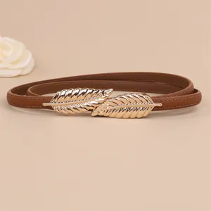 Slim brown leather belt for women with elegant gold leaf metal buckle for dresses and coats.