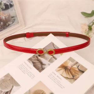 Red patent leather thin belt for women, elegant slim waist accessory for dresses and jeans.
