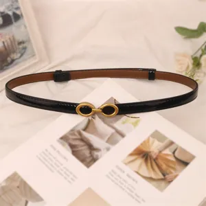 Slim black patent leather women belt with vintage metal buckle, ideal for dresses and jeans.