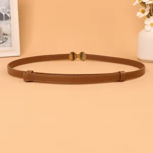 Brown thin leather belt for women, elegant metal buckle, adjustable waist strap detail.