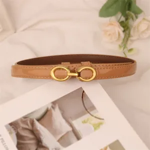 Brown patent leather women belt with metal buckle, elegant slim accessory for dresses.
