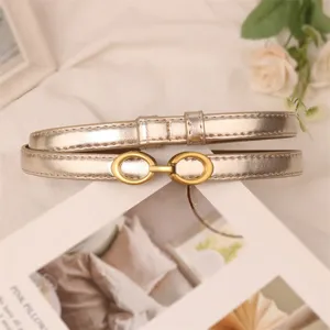 Elegant metallic gold thin belt for women, stylish minimalist dress and jeans accessory.