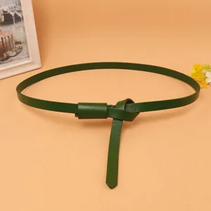 Detailed view of a dark green thin cowhide leather belt for women's dress decoration