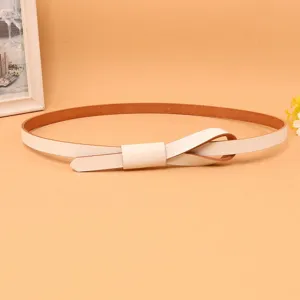 Macro view of a slim white leather belt for women tied in a minimalist decorative knot.