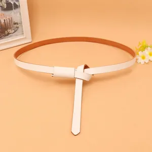 Close-up of white skinny genuine leather belt for women with knotted tie detail