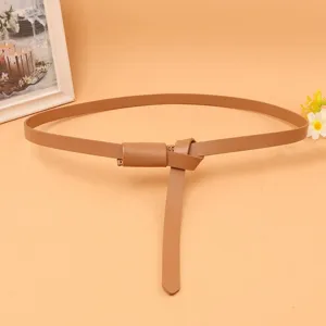 Detail of a thin brown women's leather belt tied in an elegant decorative knot style.