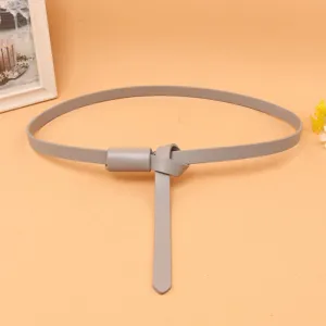 Close-up detail of a minimalist thin grey leather belt showing the stylish knot.