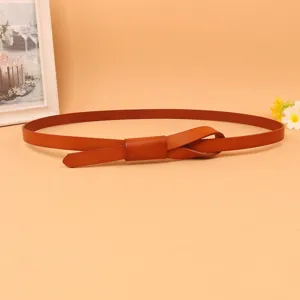 Detailed view of the knotted buckle on a slim brown genuine leather belt for women