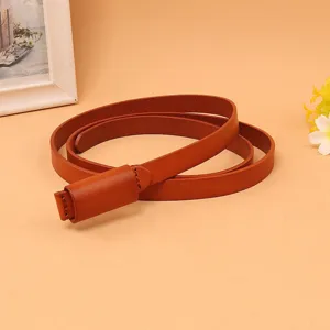 Detailed view of brown leather belt with unique buckle-less loop closure for dresses.