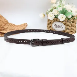 Closeup of brown genuine leather belt with hollow pattern and metal pin buckle detail