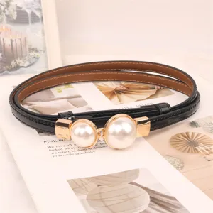Close-up of elegant black thin belt with a large double pearl buckle decoration