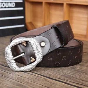 Retro brown leather belt detail showcasing the ornate silver pin buckle and embossed anchor pattern.