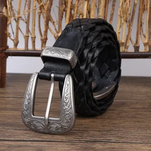 Close-up of a vintage black braided leather belt with an engraved silver buckle.