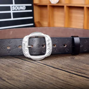 Vintage brown wide belt with ornate silver buckle and debossed pattern, stylish accessory.