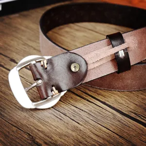 Vintage brown leather belt with silver pin buckle and unique screw detail for daily wear.