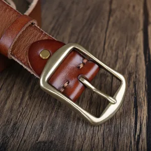 Closeup detail of genuine leather men belt brass buckle retro style craftsmanship texture view.