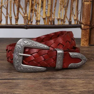 Close-up detail of a vintage reddish-brown woven leather belt with ornate silver buckle
