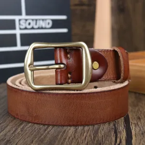 Men's genuine leather belt detail showcasing brass pin buckle and fine stitching texture.