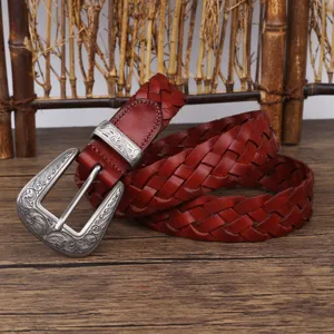 Detailed view of a retro reddish-brown woven leather belt with an engraved silver buckle
