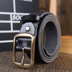 Close-up view of genuine leather belt buckle, featuring detailed stitching and vintage hardware texture.