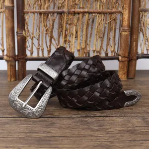Premium vintage brown woven leather belt featuring an ornate carved silver buckle detail