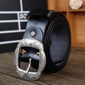 Vintage black leather belt with ornate carved silver metal buckle, retro waist item.