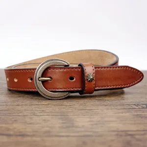 Vintage brown leather belt detail, classic brass buckle, stylish coat dress accessory.