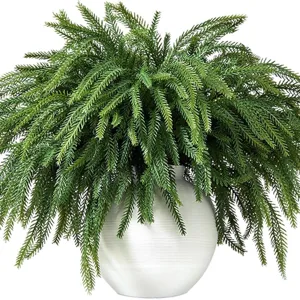 Lush artificial Norfolk Pine in a white ribbed vase for elegant home Christmas decoration
