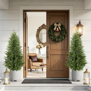 Pair of lifelike PE Norfolk Pine trees flanking a classic wooden front door